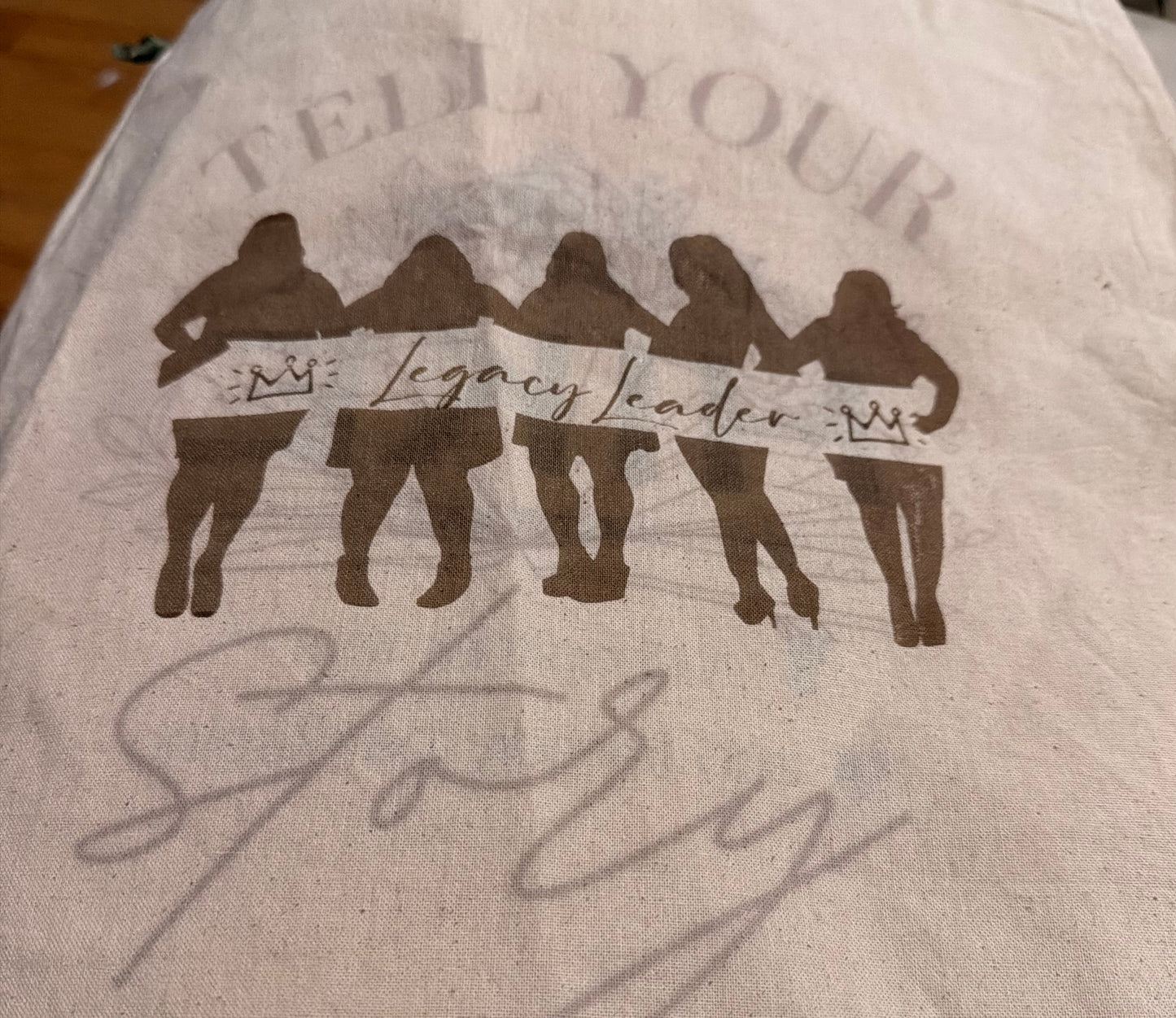 Beige canvas bag with engraved  graphic design. 