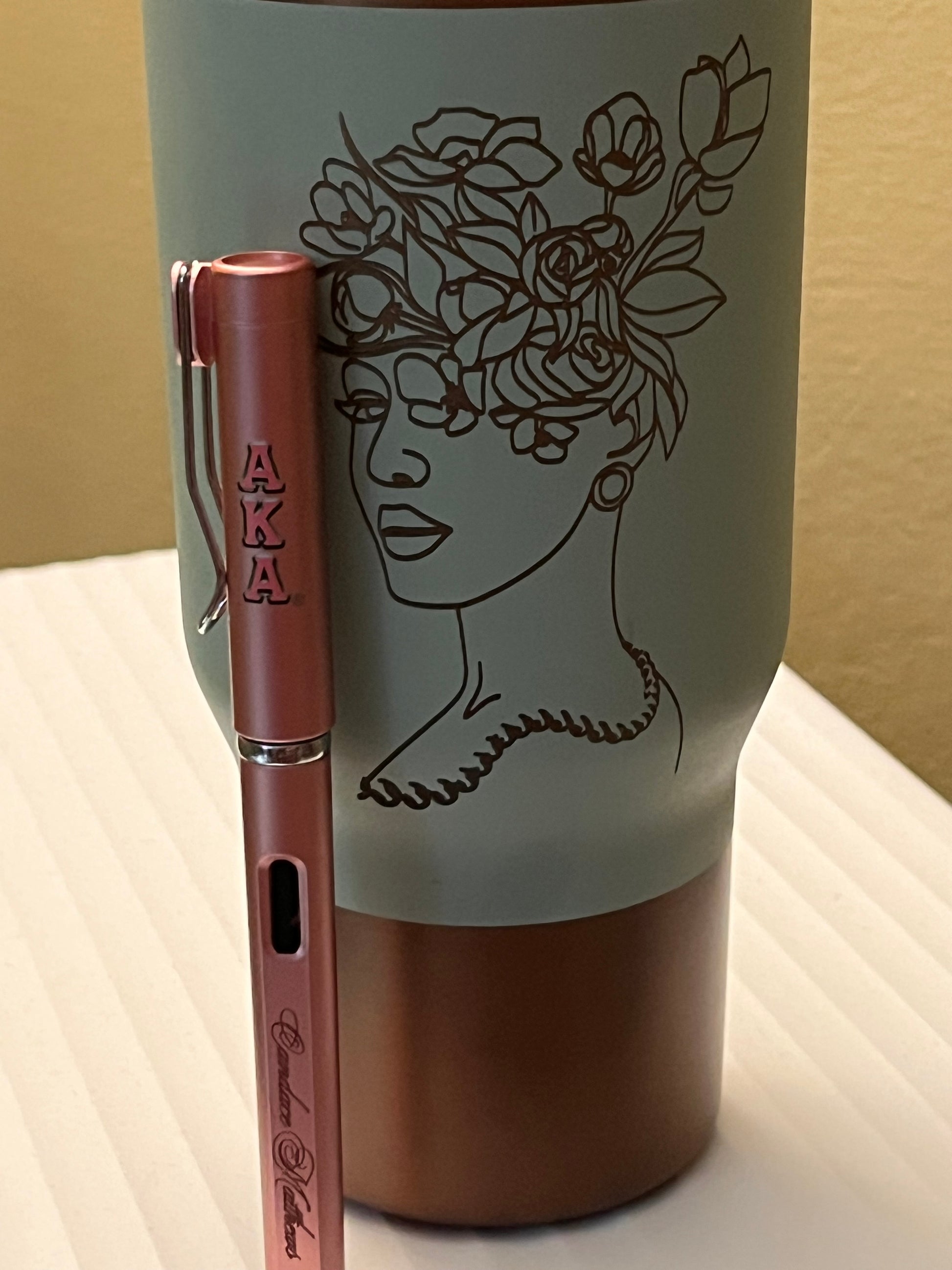 Pen with decorative case featuring a design of a lion and flowers on a beige background